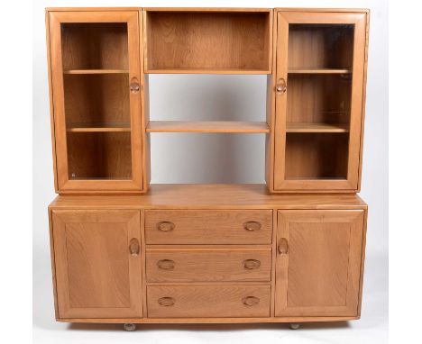 Ercol: an elm Windsor sideboard and display cabinet, with lights and tipped glass shelves, 156 × 44 × 162 cms high.