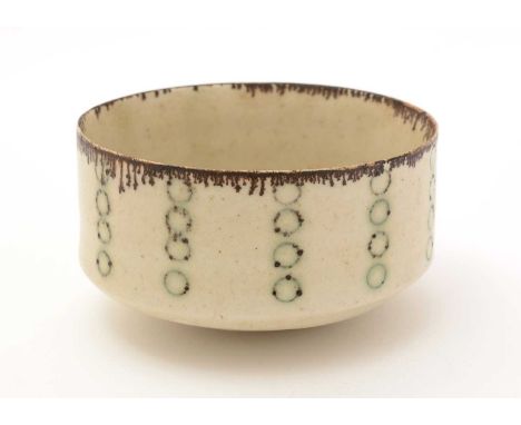 Dame Lucie Rie (1902-1995). A porcelain bowl, with straight sides and shallow tapering foot, impressed with pale green pendan