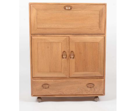 Ercol: an elm Winsor No. 430 serving cabinet, the rectangular top/carving flap and shelved interior, double door below enclos