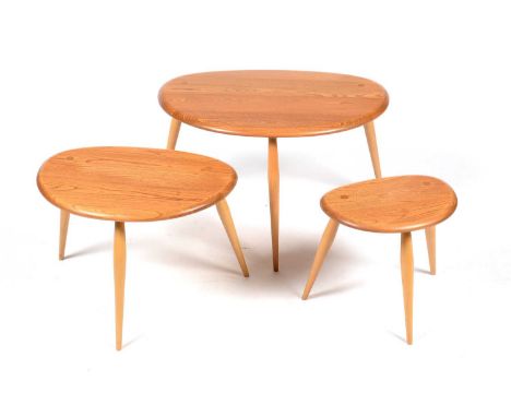 Ercol: a nest of three model 354 'Pebble' occasional tables, the largest 64 x 44 x 40cms, the smallest 34 x 24 x 34cms high. 