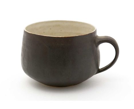 Dame Lucie Rie (1902-1995). A fine stoneware large handled cup with matte chocolate brown glazed exterior, impressed LR monog