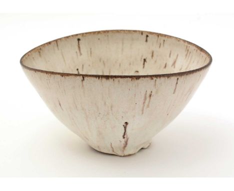 Dame Lucie Rie (1902-1995). An oval stoneware bowl with thick streaked glaze with manganese spots and inclusions, oxidized br