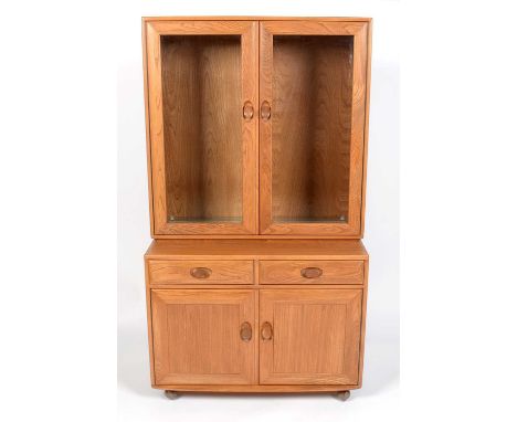 Ercol: an elm Windsor glazed cabinet, with lights and tipped glass shelves, 91 × 44 × 93cms high.