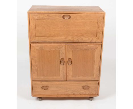 Ercol: an elm Winsor No. 430 serving cabinet, the rectangular top/carving flap, single drawer to base, opening to reveal a va