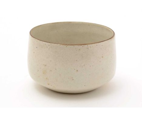 Dame Lucie Rie (1902-1995). A small straw glazed stoneware Bowl, with pitted glaze and brown oxidized rim, applied LR monogra