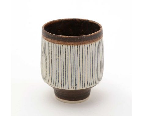 Dame Lucie Rie (1902-1995). A small porcelain cup with short tapered foot, the exterior with fine vertical lines, matte choco