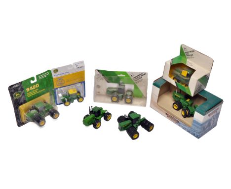 An assortment of 1/64 diecast farm model issues comprising John Deere 4WD and Vintage tractor models. Some with boxes.