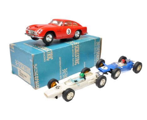 A trio of Scalextric cars including a very good example of the Aston Martin DB4 GT.