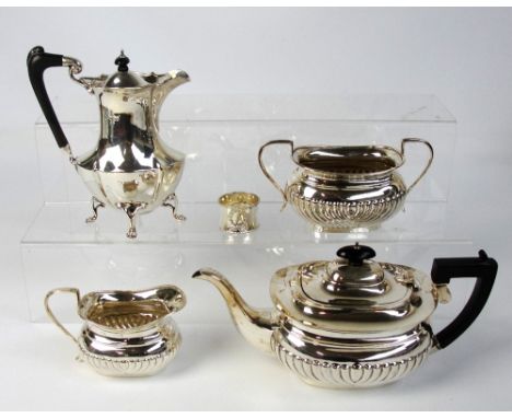 A George V hallmarked silver three piece tea service with gadrooned decoration comprising a teapot of oval form, a cream jug 