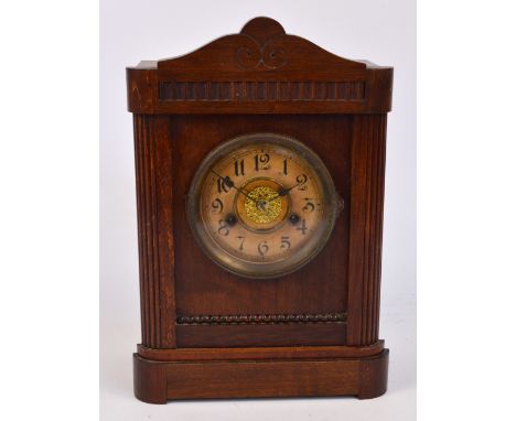 An American eight day beech wood cased mantel clock, the circular dial set with Arabic numerals, height 34.5cm.