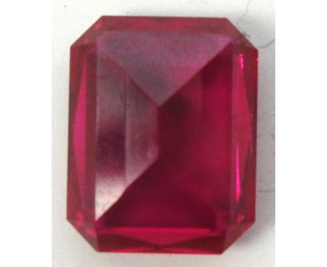 A loose emerald cut ruby, approx 3.5cts. CONDITION REPORT: A minute chip to one corner, literally 1mm x a fraction of a milli