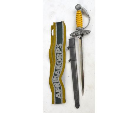 A miniature 2nd pattern Luftwaffe dagger, the blade inscribed "Besmer-Teppiche", and an Afrikakorps band (2).