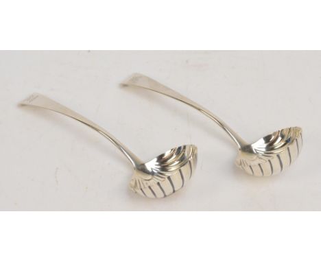 A pair of George III hallmarked silver sauce ladles with engraved arrow armorial to the handles, and with scallop moulded bow