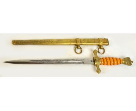 A WWII Nazi Kriegsmarine 2nd model dagger with wirework bound amber coloured and etched blade inscribed "WKC" with button rel