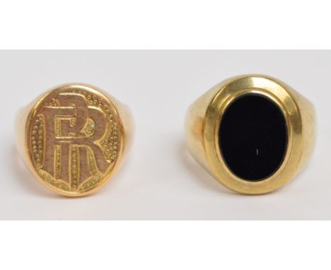 A 14ct yellow gold gentleman's signet ring, initialled RR to the oval top, size Q/R, and a yellow metal example set with blac