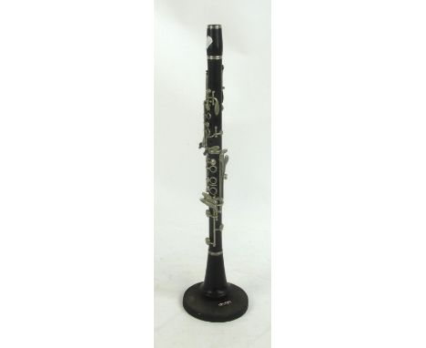 A Lucian Bassi clarinet on stand (mouthpiece missing).