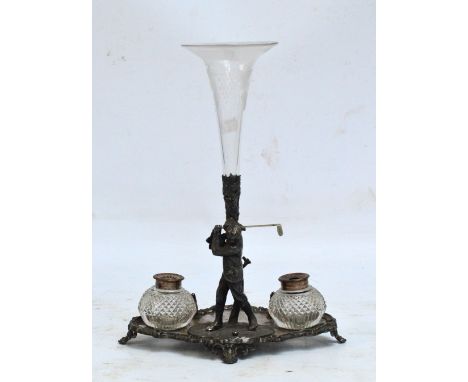 An Edwardian electroplated inkstand/epergne with a figure of a golfer taking a swing, with two clear cut glass inkwells and p