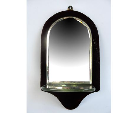 A late Victorian mirrored wall bracket with single shelf and arched frame, length 35cm.