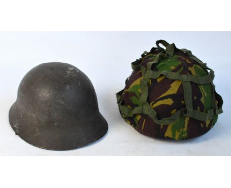 A military helmet with camouflage cover and a further helmet stamped "L.I.69" (2).