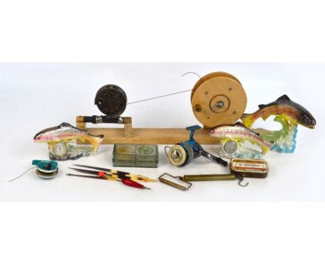 A collection of various fishing tackle including Intrepid reel, Ambidex casting reel, hooks, weights, flies, ceramic trout et