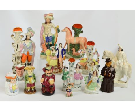 Seven Staffordshire flatback figures including "Forester" and spill vases, and another example, also five toby jugs including
