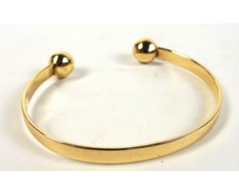 A 9ct yellow gold torque bangle, diameter 6cm, approx 22.1g.