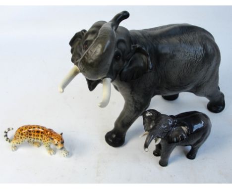 Two Beswick figures of elephants; a matt glazed "Elephant-Trunk in Salute" no.1770 and "Elephant-Trunk Stretching-Small" no.9