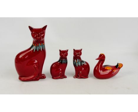 A small collection of Poole Pottery Delphis animals all with painters marks to base, comprising a pair of cats, height 16.5cm
