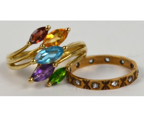 A 9ct yellow gold ring of abstract form set with five various coloured cut gemstones, size M and a 9ct full eternity ring set