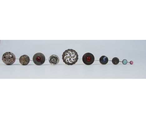 A collection of various vintage hatpins including a pair with flat button heads centred with amber glass, an example with fil