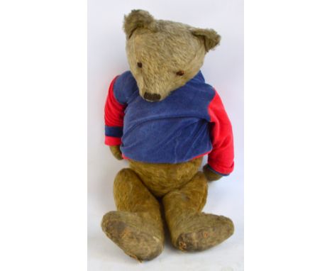 A mid 20th century straw filled Steiff bear with glass eyes, height 72cm. The owner has removed the button as a child.