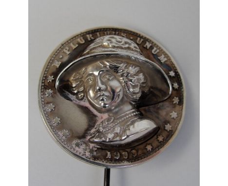 An Edwardian hallmarked silver hatpin, the articulated head bearing a head and shoulder relief portrait of Emmeline Pankhurst