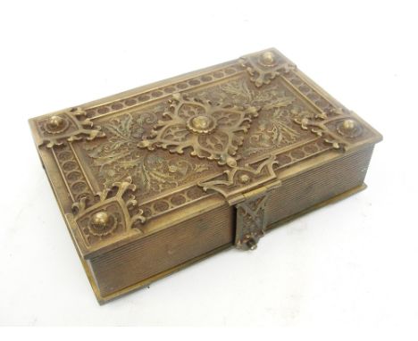 A Victorian novelty brass trinket box in the form of an elaborately decorated book with thistle ornaments, with wooden interi