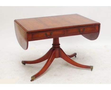 A reproduction yew wood sofa table.