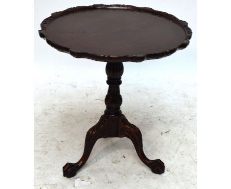 A reproduction mahogany circular dished tilt top occasional table with baluster ring turned central column and three knee car