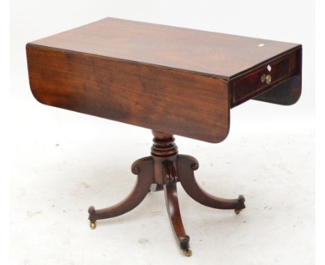 A William IV mahogany Pembroke table, with frieze drawers to both sides, on ring turned column with four sabre legs and casto