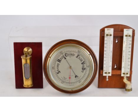 A mid 20th century circular wooden barometer, diameter 21.5cm, a wet and dry hydrometer on a wooden hanging stand by Griffin 