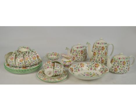 A large quantity of Minton "Haddon Hall" tea and dinner ware including dinner plates, pudding bowls, soup bowls, serving dish