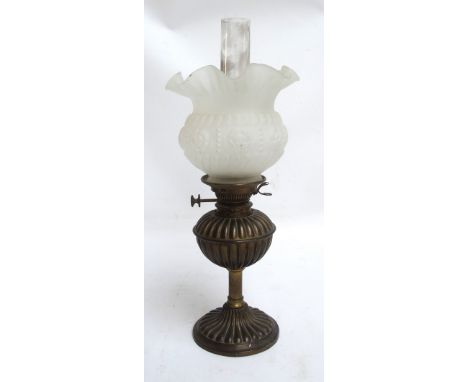 A late Victorian brass oil lamp with frosted globular shade, height 52cm.