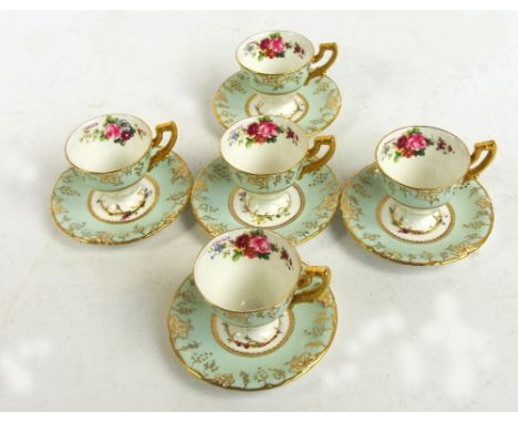 A set of five Royal Crown Derby "Vine" pattern cups and saucers with floral transfer and hand painted decoration, signed "F G