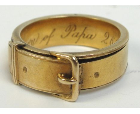 An unusual Victorian yellow metal mourning ring, the band set as a belt with release clasp opening to reveal two bands of pla