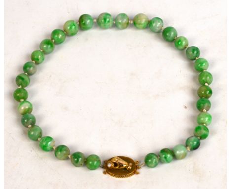 An apple green jade bead necklace with 9ct gold oval clasp set with a hand holding a small cultured pearl, length approx 44cm