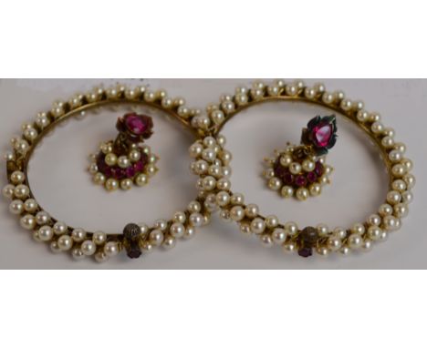A pair of cultured pearl set snap bangles with ruby clasps, and a matching pair of earrings with marquise ruby in floral sett