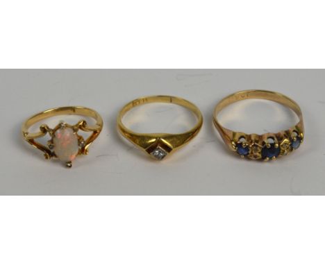 An 18ct yellow gold and diamond solitaire ring, size M, a further example set with opal and four diamond chips, size G, and a