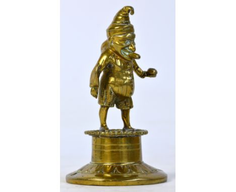 A Victorian brass "Mr Punch" bar lighter with hole through the cigar in Mr Punch's mouth and fixings to attach it to the bar,