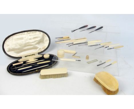 A mixed lot of various ivory and ivorine dressing table items including three pairs of brushes, a German cased pedicure set (