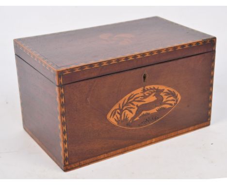 A late George III mahogany and inlaid tea caddy with decorated edges and centred with a running stag within oval border, with