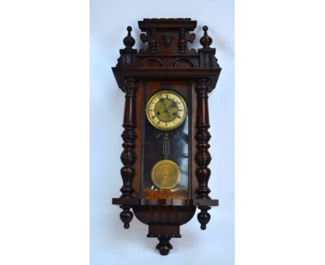 A late 19th century Vienna style eight day spring driven stained beech and walnut cased wall clock, the circular dial set wit