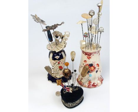 A large collection of vintage hatpins including examples with pearl beads, ivory decorated, jet, white metal insect and drago