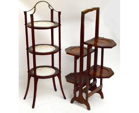 An oak double sided folding cake stand, height 86cm and a mahogany example with central brass handle and three ceramic plate 